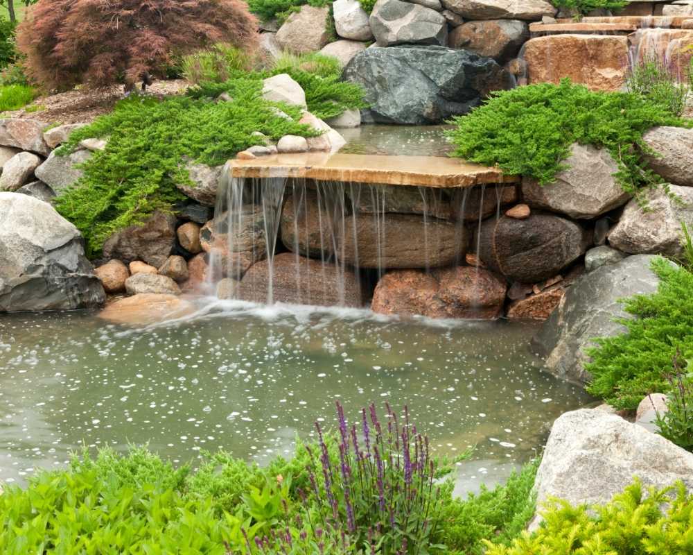 small backyard with masonry waterfall